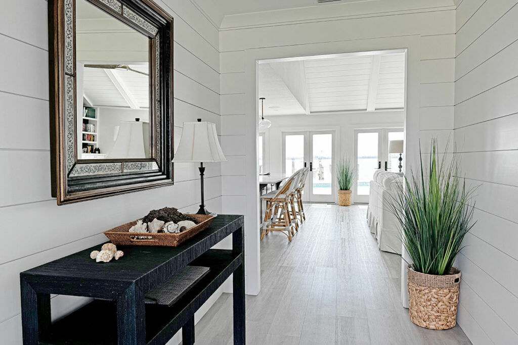 Coastal-style hallway with mirror and plants